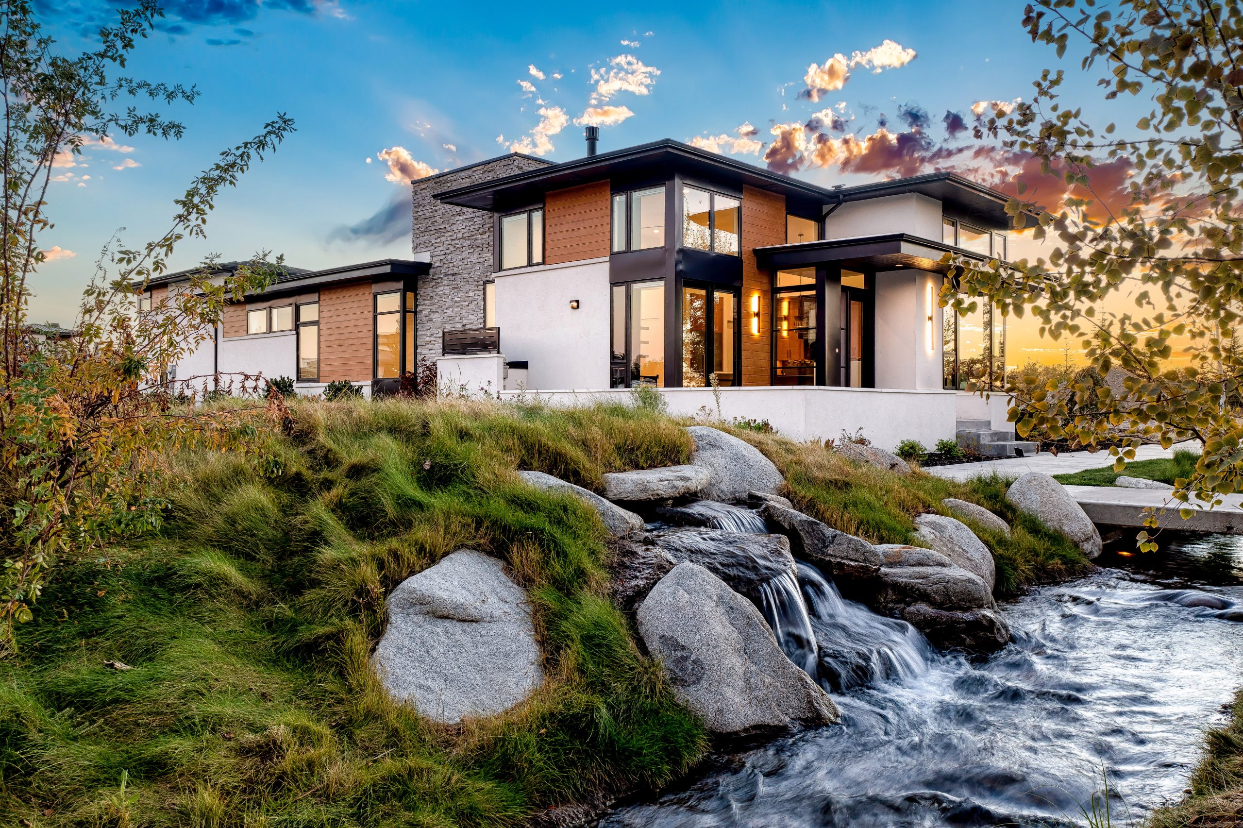 Aerial view of contemporary waterfront home at dusk, located at the Renovare community in Eagle