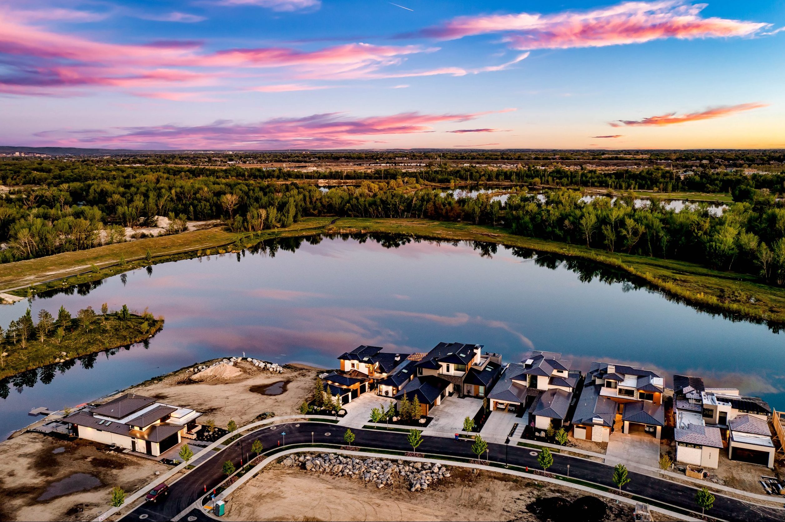 Aerial view of waterfront luxury homes in the Renovare community with adjacent available lots under construction