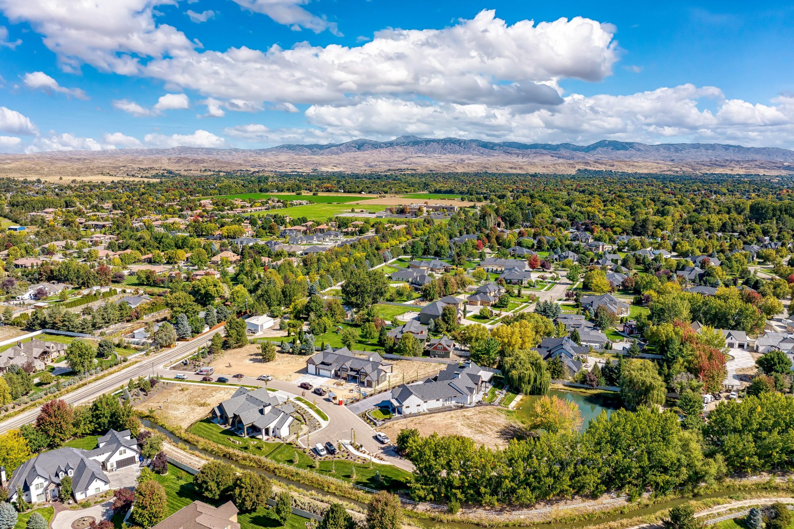 Aerial view of the Arrano Farms boutique community with bright blue sky and lush foliage and greenery surrounding